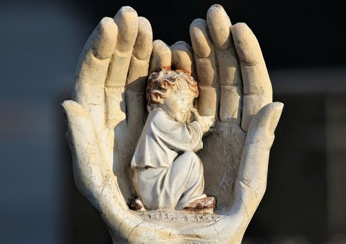 little angel  resting in hands  figure