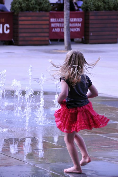 little girl dance water jets