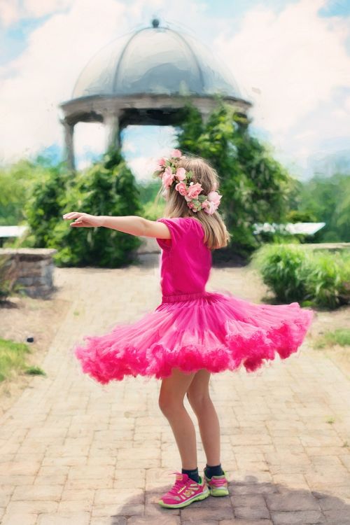 little girl twirling dancing outdoors