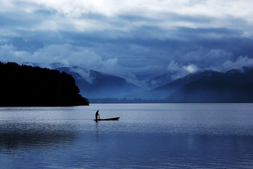 lugu lake early in the morning fishing