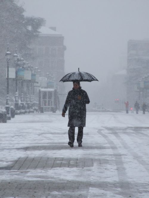 madrid snow walk with snow man with umbrella