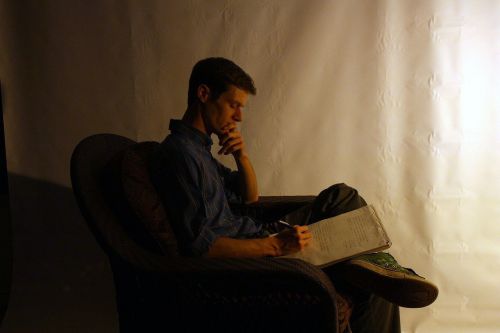 male reading sitting