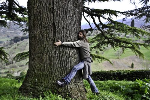 man tree hugging