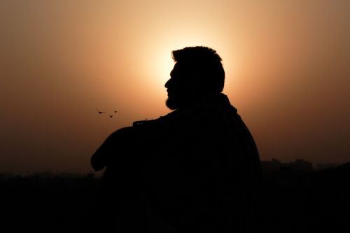 man silhouette sitting