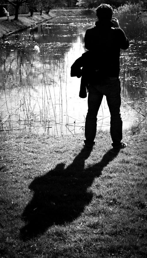 man taking photo shadow