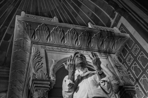 man praying mosque