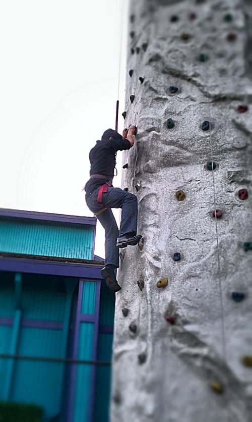 man climbing mountain