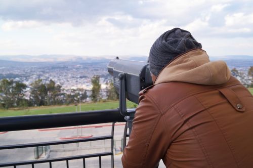 man observing binoculars