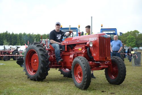 man on tractor red tractor old tractor