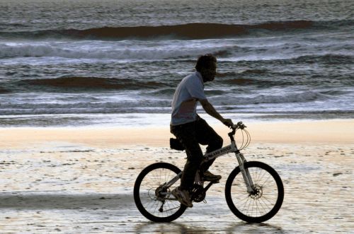 Man Riding Bike By Ocean