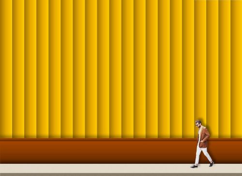 man walking yellow wall