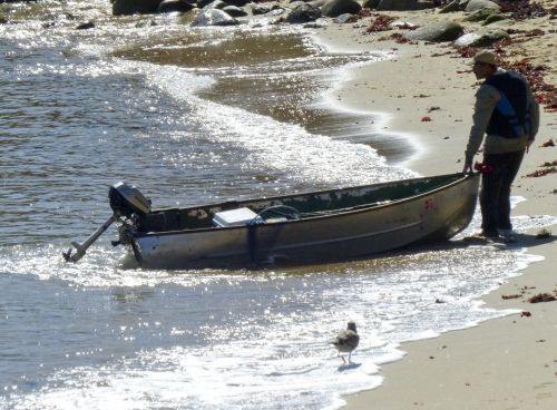 Man With A Boat On The Beach