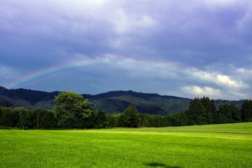 meadow clouds rainbow