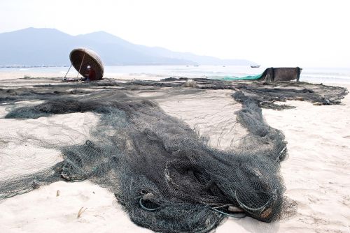 mending their nets the fishermen fishery