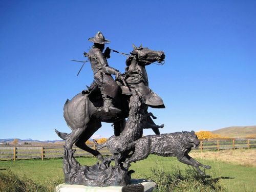 metal sculpture coyotes horse
