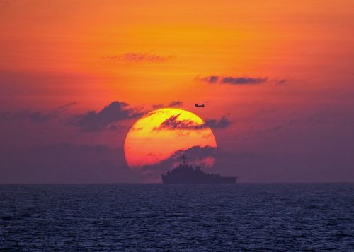 military ship sunset sea