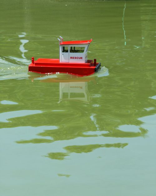 Model Boat Reflecting In Water