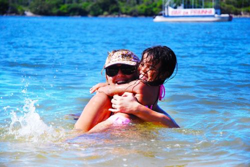 mother and daughter swimming beach