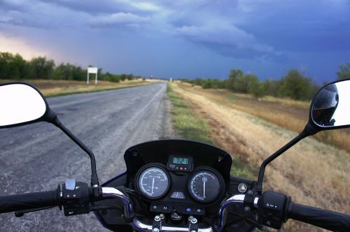 motorcycle road dark sky