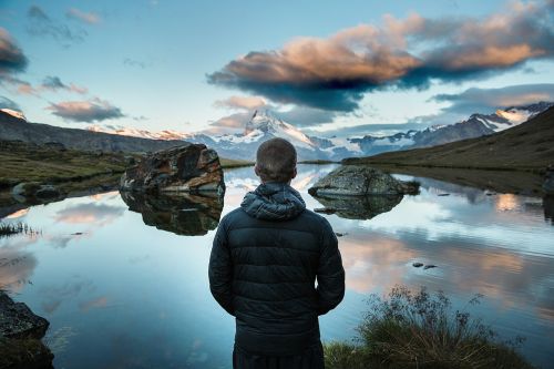 mountain lake person looking