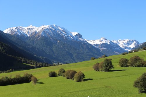 mountains  blue sky  green meadow