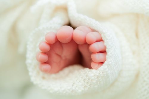newborn toes white blanket close up