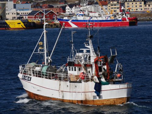 norwegian fishing boat heading out to sea calm sea