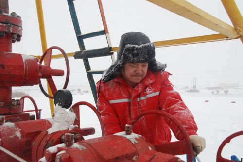 oil workers in the snow valve