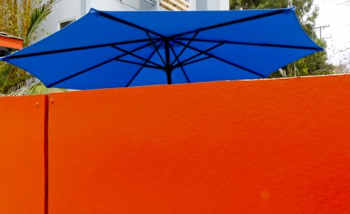 Orange Wall Blue Umbrella