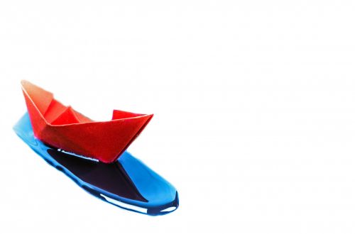Paper Boat On The Water Drops