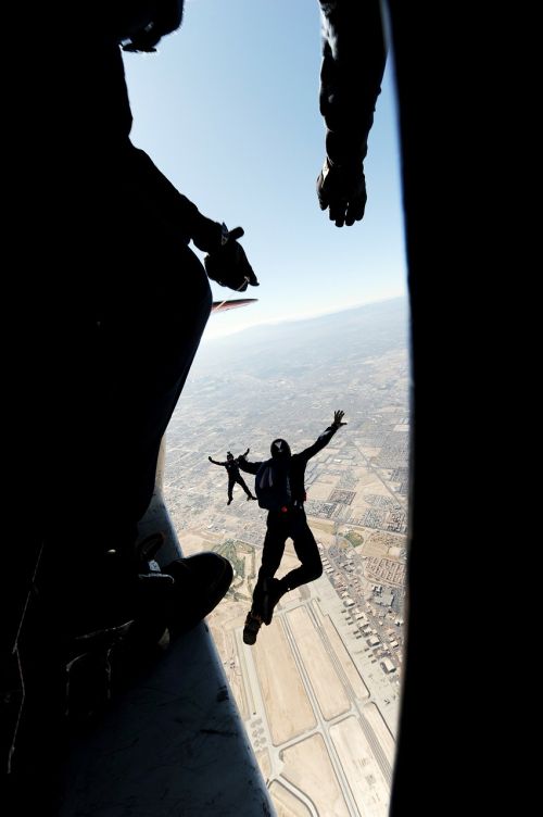 parachutist jumping landscape