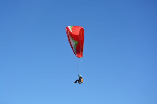 paragliding red sail blue sky
