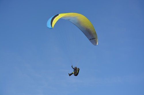 paragliding  paraglider  sailing blue yellow