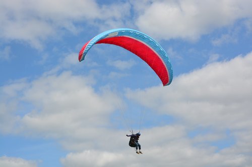 paragliding  red wing blue  sailing