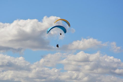 paragliding  paraglider  paragliders duo blue sky cloudy