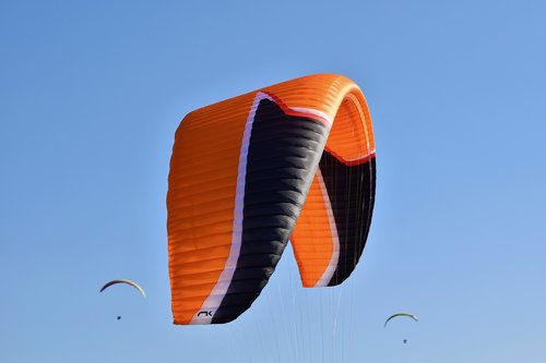 paragliding  paraglider  sailing orange