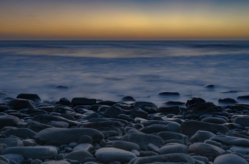 pebbles sea sunset