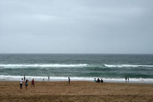 People On Beach On A Still Morning