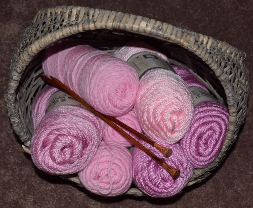 pink yarn knitting needles basket