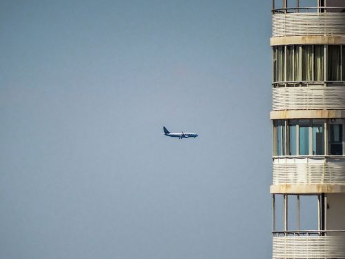 plane building sky