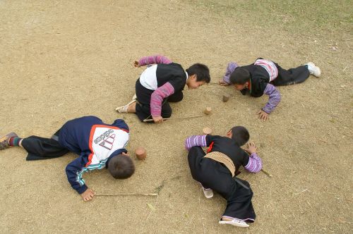 four children uplands spinning on the ground