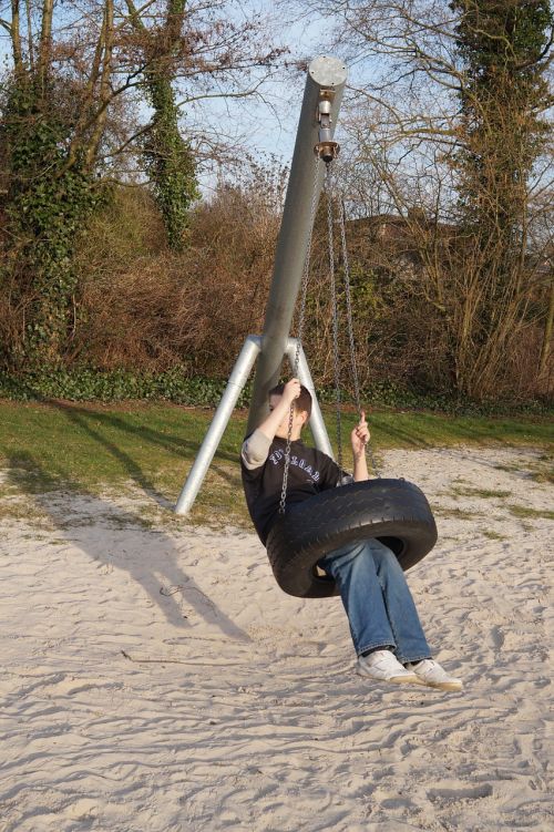 playground tire swing boy