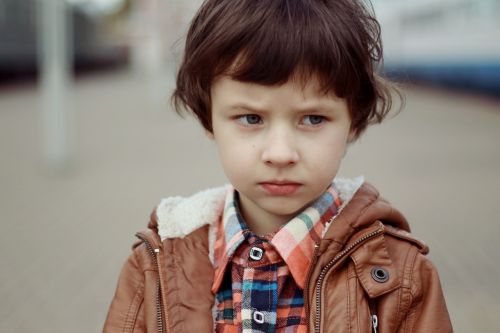 portrait of a boy boy frowning