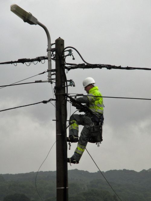 power pole worker electric wires