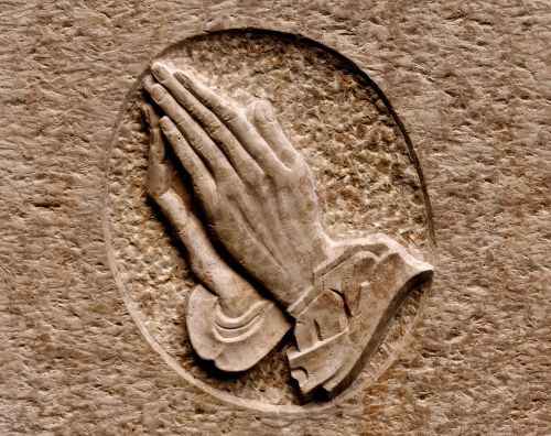 praying hands religious stone