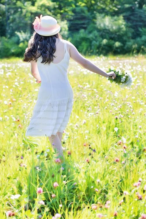 pretty girl in wildflowers meadow summer