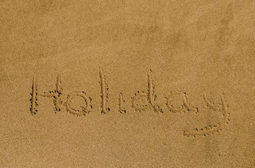 &quot;Holiday&quot; Written In The Sand