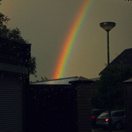 rainbow rain shower threatening sky