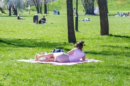 reclining woman  holiday in the park  lawn