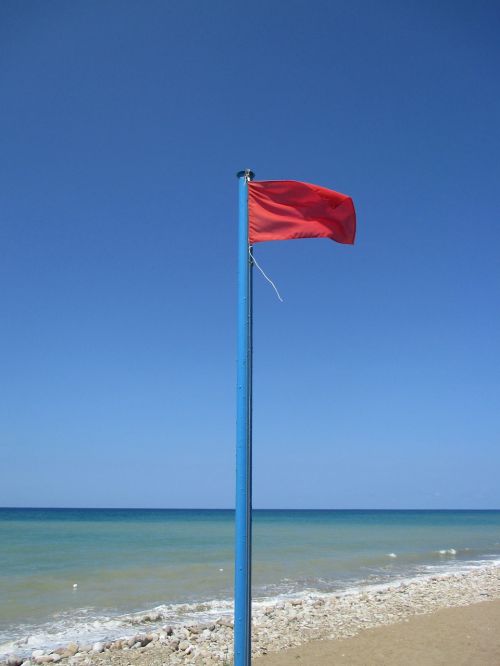 red flag sea beach